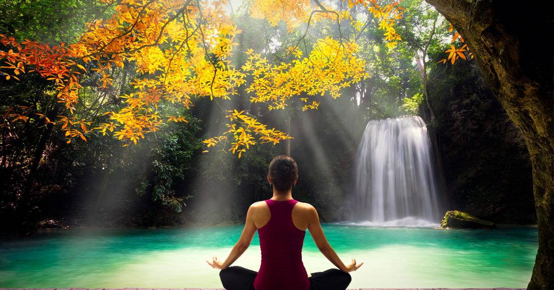 Benefits of meditation. Words of Wisdom Blog. Lady meditating in front of cascading waterfall
